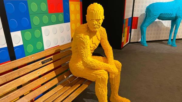 “Parkbench” by Nathan Sawaya, co<em></em>nstructed entirely of yellow Legos, now on view in a Raleigh gallery.