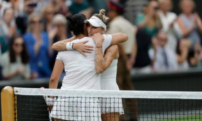 Marketa Vo<em></em>ndrousova hugs Ons Jabeur after winning the Wimbledon title.