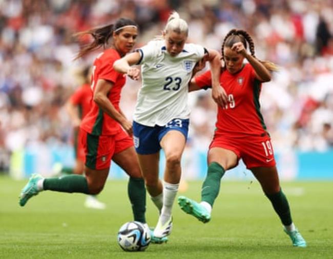 Alessia Russo of England runs with the ball under pressure during the friendly against Portugal